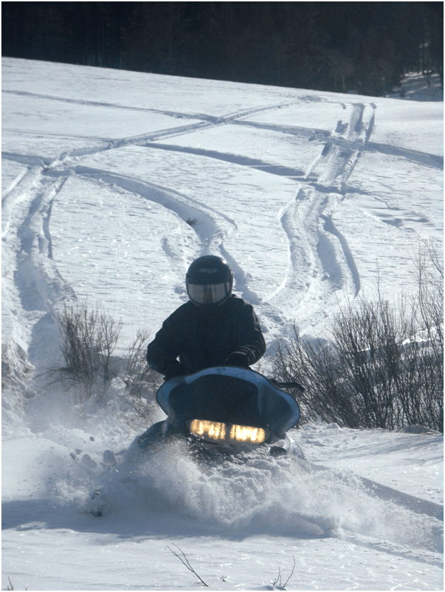 Snowmobiling4 RealRanchers Jim and Timmery Hellyer from Lander, Wyo. take a break from feeding their beef cattle to snowmobile.