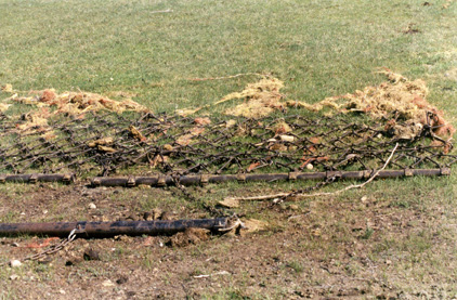 A drag is pulled across pastures to break of manure and make its nutrients more accessible to plants