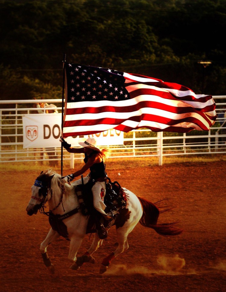 Rodeo Queen carries flag on horse
