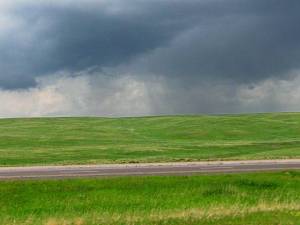 Green prairie and storm