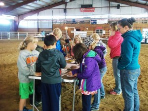 Mary Evans and Sydney Burek from the Platte County Resource District teach students what can be learned by studying tree rings at the 2014 Laramie Peak CattleWomen Ag Expo