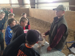 Austin Pedersen teaches students about chickens at the 2014 Laramie Peak CattleWomen Ag Expo.